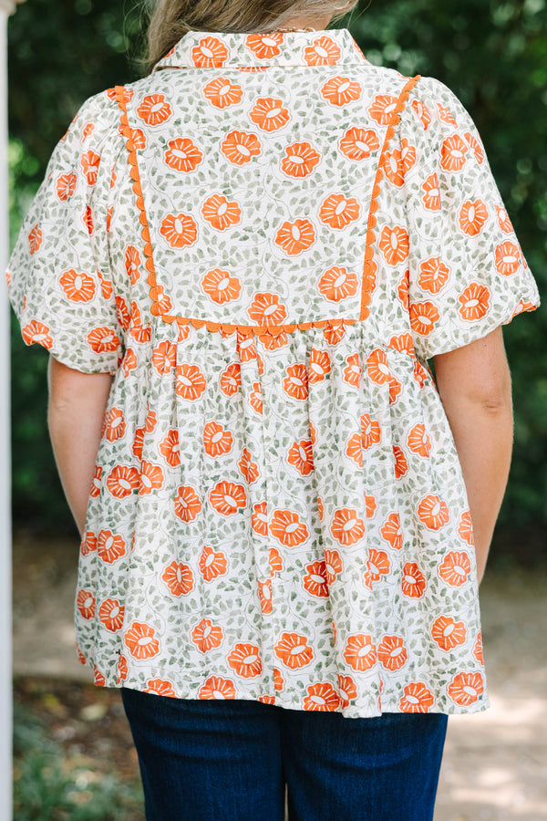Plus Size floral babydoll top in burnt orange and green with a square yoke and short puff sleeves.
