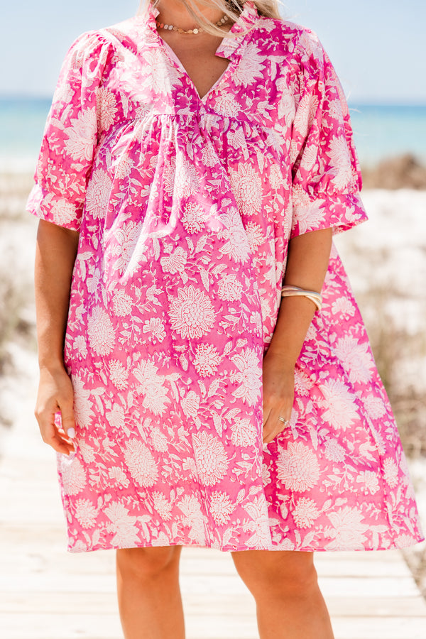 Plus Size pink floral cotton dress with puffed short sleeves, a v-neckline, and a relaxed fit.