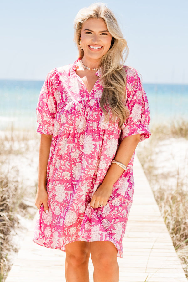 Plus Size pink floral cotton dress with puffed short sleeves, a v-neckline, and a relaxed fit.