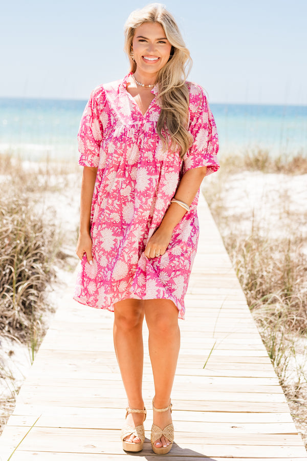 Plus Size pink floral cotton dress with puffed short sleeves, a v-neckline, and a relaxed fit. 
