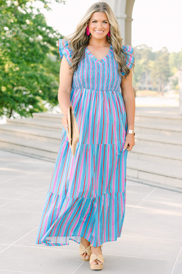 Plus Size blue tiered maxi dress with multi-colored stripes, smocked bodice, and flutter sleeves.
