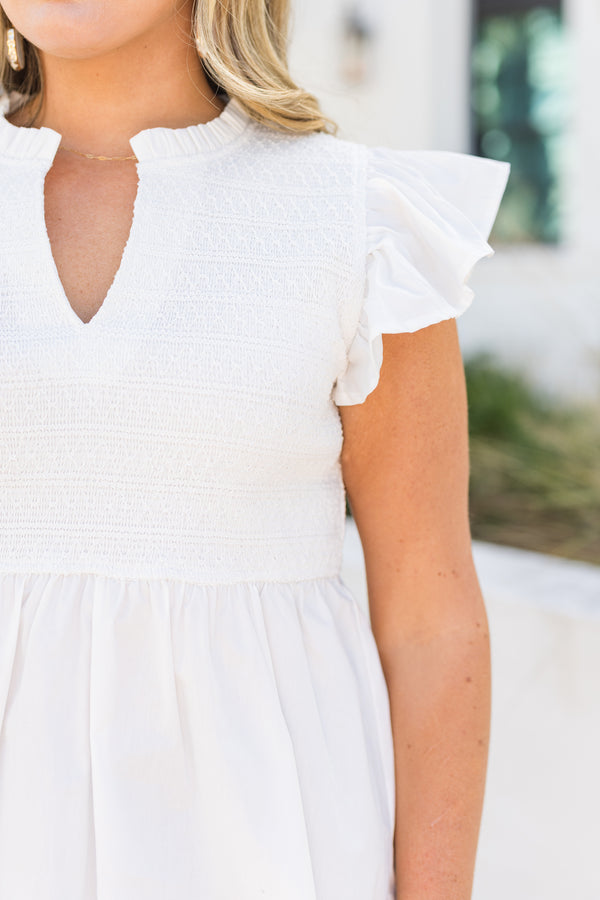 Chic Soul plus size clothing, white top with flutter sleeves and smocked detailing on the chest area and then a flare out from under the bust as well a v-neckline 