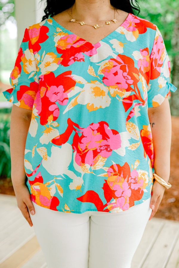 Chic Soul plus size clothing, blue short sleeve top with a multi-color floral pattern and a slight v-neck 
