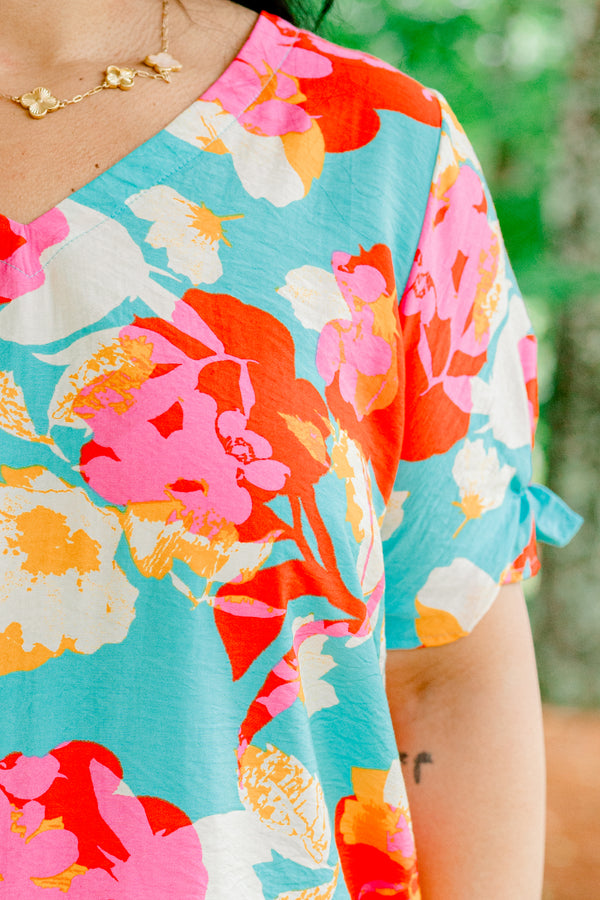 Chic Soul plus size clothing, blue short sleeve top with a multi-color floral pattern and a slight v-neck 