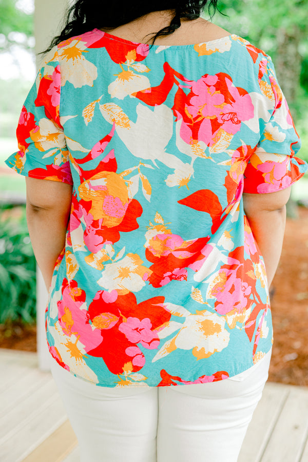 Chic Soul plus size clothing, blue short sleeve top with a multi-color floral pattern and a slight v-neck 