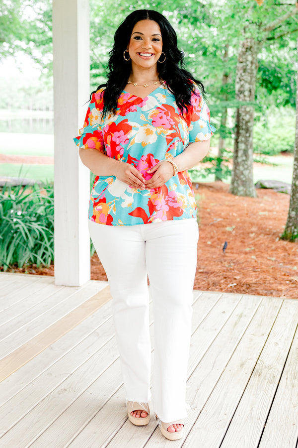 Chic Soul plus size clothing, blue short sleeve top with a multi-color floral pattern and a slight v-neck 