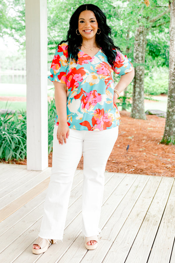 Chic Soul plus size clothing, blue short sleeve top with a multi-color floral pattern and a slight v-neck 