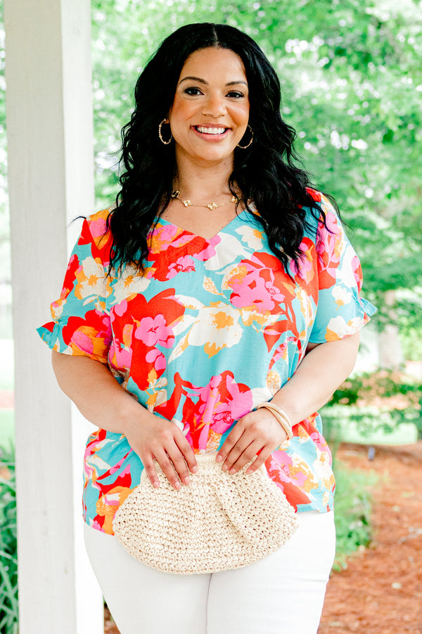 Chic Soul plus size clothing, blue short sleeve top with a multi-color floral pattern and a slight v-neck 