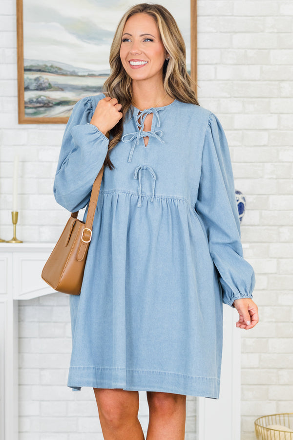 Plus Size light denim babydoll dress with a split v-neck, front bow details, and balloon sleeves.