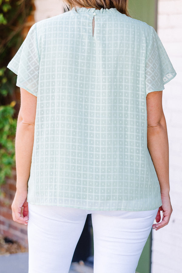 Chic Soul plus size clothing, short-sleeve sage green top with high smocked neckline and subtle square geometric pattern 