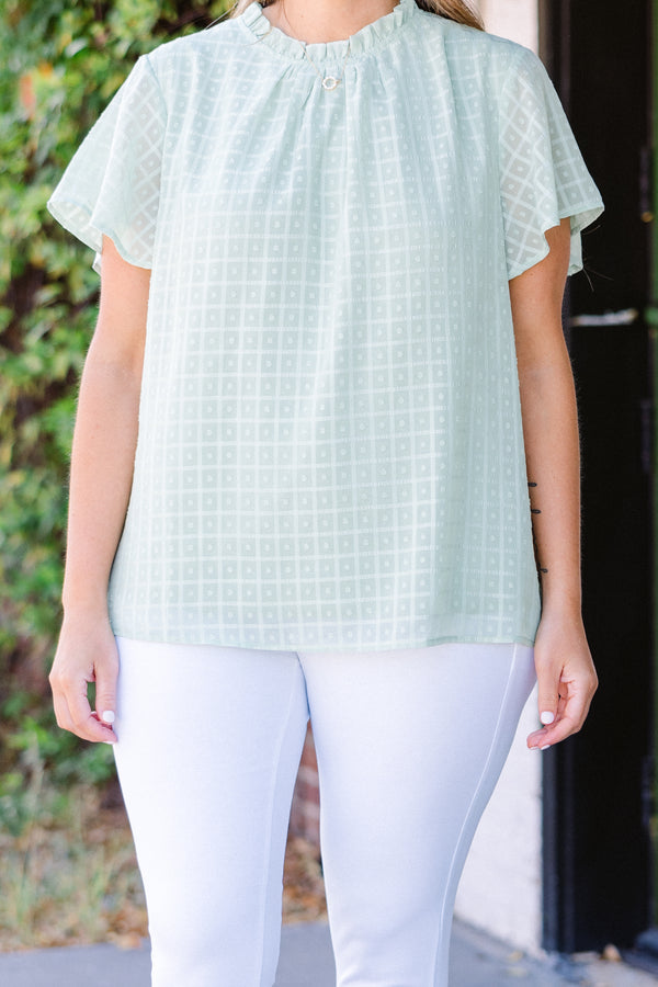 Chic Soul plus size clothing, short-sleeve sage green top with high smocked neckline and subtle square geometric pattern 