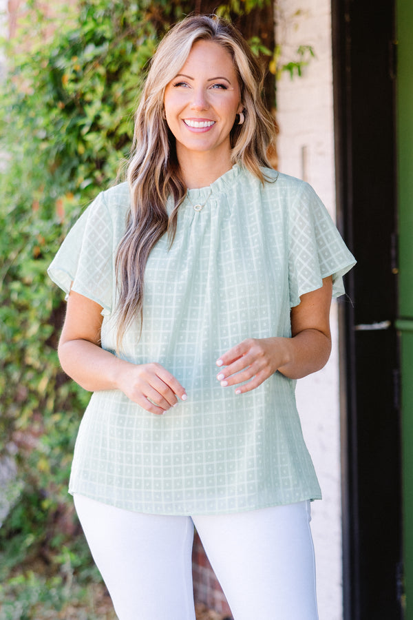 Chic Soul plus size clothing, short-sleeve sage green top with high smocked neckline and subtle square geometric pattern 