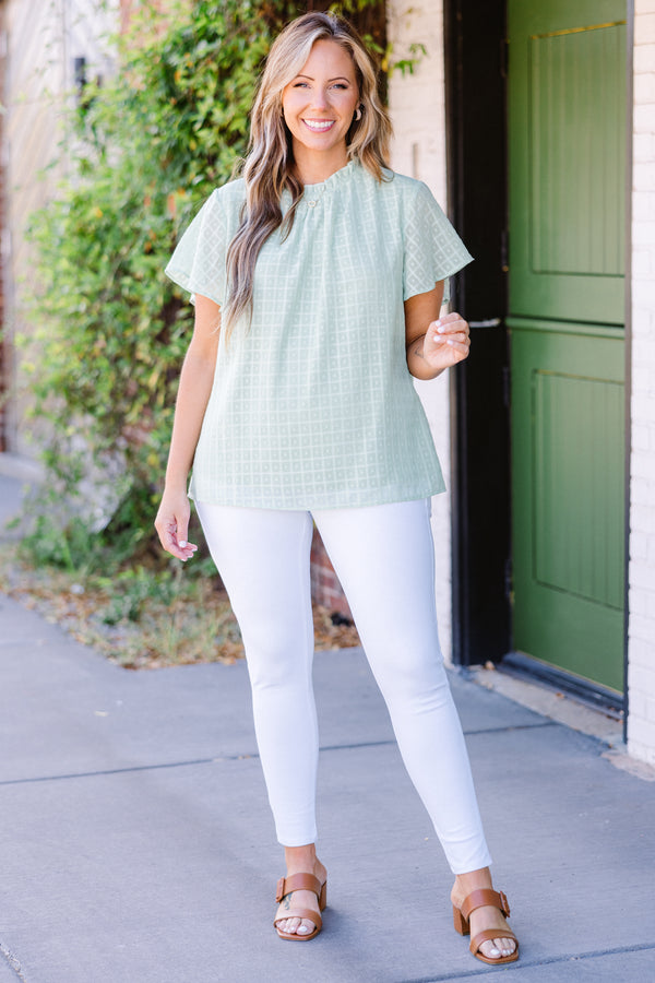 Chic Soul plus size clothing, short-sleeve sage green top with high smocked neckline and subtle square geometric pattern 