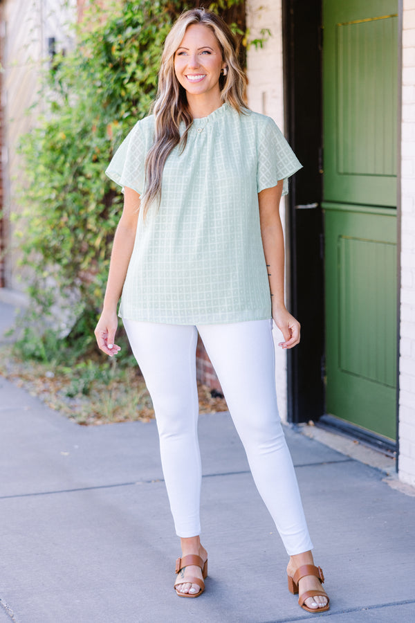 Chic Soul plus size clothing, short-sleeve sage green top with high smocked neckline and subtle square geometric pattern 
