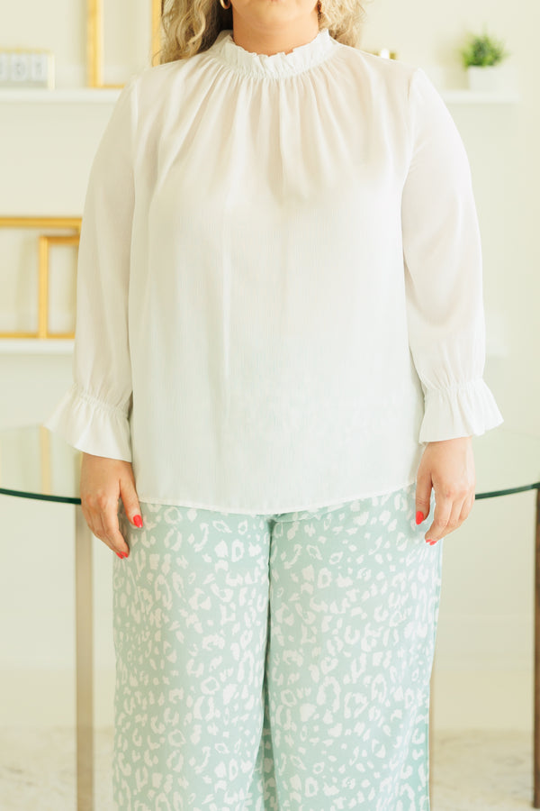 Plus Size white high-neck top with ruffled collar and cuffs paired with mint leopard print pants.