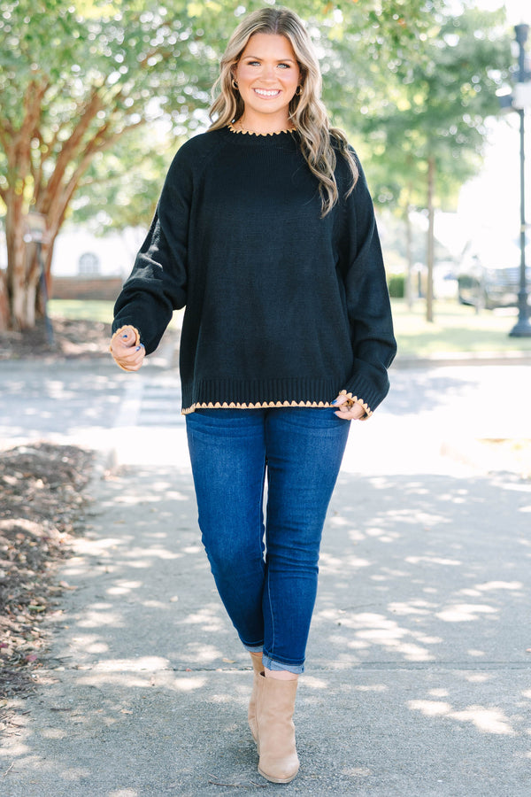 Plus size black knit sweater with tan scalloped trim on the crew neck, cuffs, and hem.