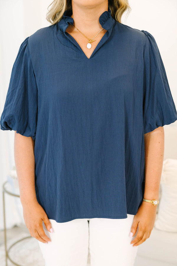 Plus Size navy blue rayon-blend top with a v-neckline, ruffled collar, and puff elbow-length sleeves.