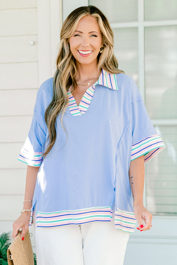 Chic Soul Plus size clothing, periwinkle casual top with short sleeves and a white cuff with colorful stripes on the bottom of the shirt, neckline, and end of the sleeves 
