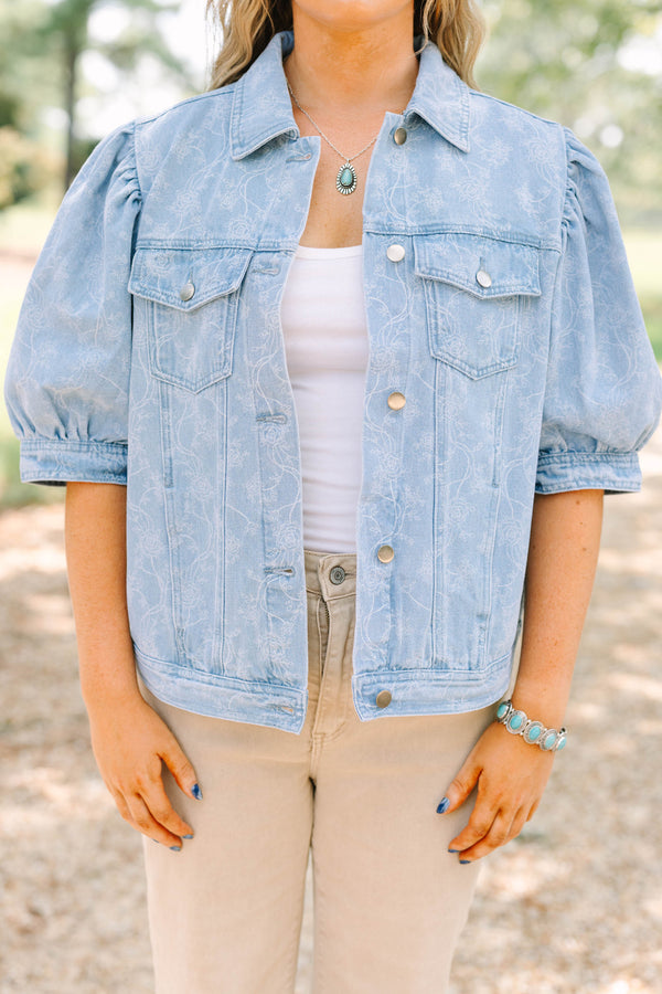 Plus Size light wash denim jacket with floral embroidery, puff sleeves, and silver buttons.