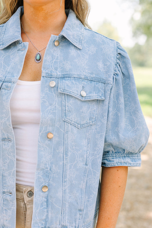 Plus Size light wash denim jacket with floral embroidery, puff sleeves, and silver buttons.