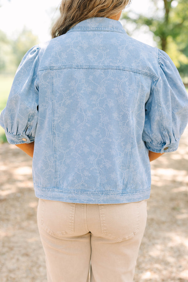 Plus Size light wash denim jacket with floral embroidery, puff sleeves, and silver buttons.