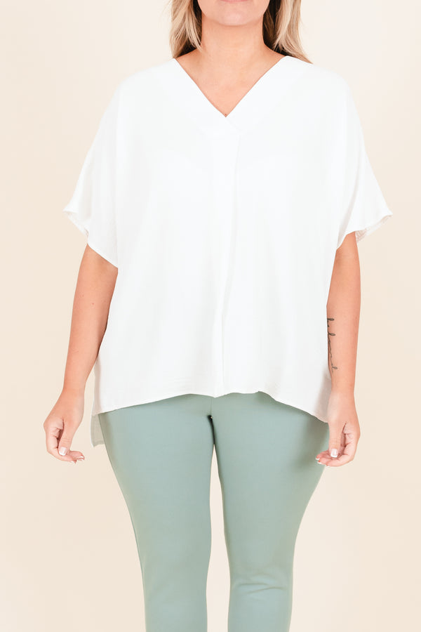 Plus Size off white flowy short sleeve top with a V-neckline and light polyester fabric.