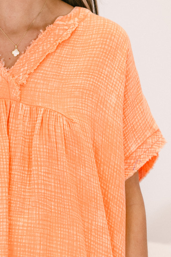 Chic Soul plus size clothing, short-sleeve cuffed pale coral orange mineral washed top with a high-low hemline and a subtle distressed v-neckline
