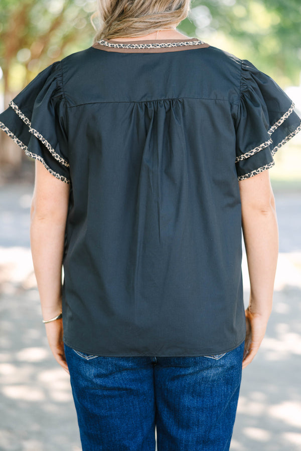 Plus Size black top with leopard print embroidery, V-neckline, and tiered flutter sleeves.