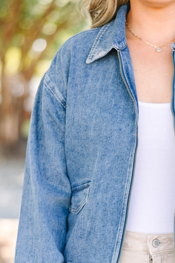 Plus size denim jacket with a zip-up front, collar, and relaxed fit.