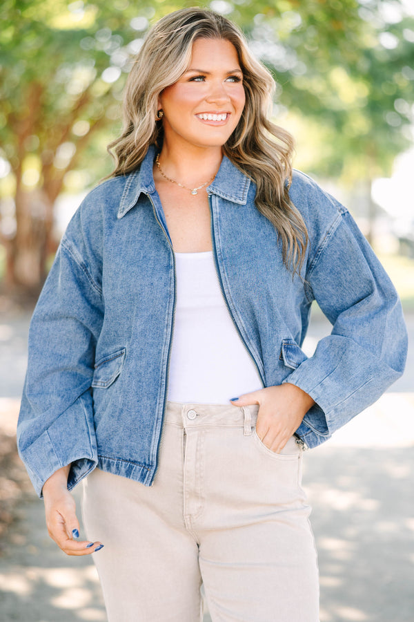 Plus size denim jacket with a zip-up front, collar, and relaxed fit.