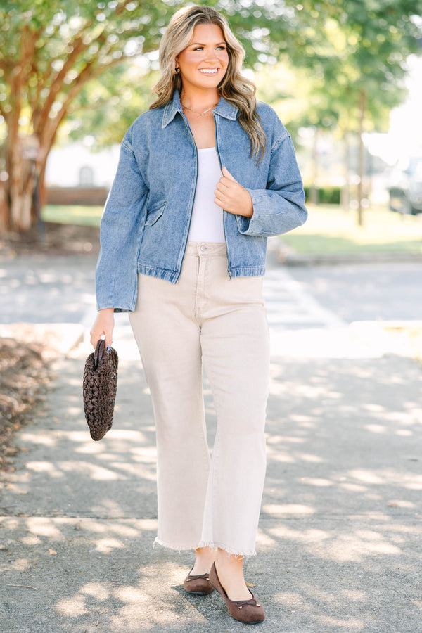 Plus size denim jacket with a zip-up front, collar, and relaxed fit.