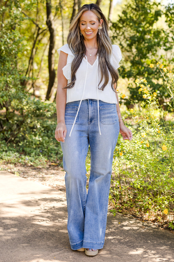 Chic Soul plus size clothing, mid-waisted medium wash straight boot-cut jeans with a subtle silver button detailing 