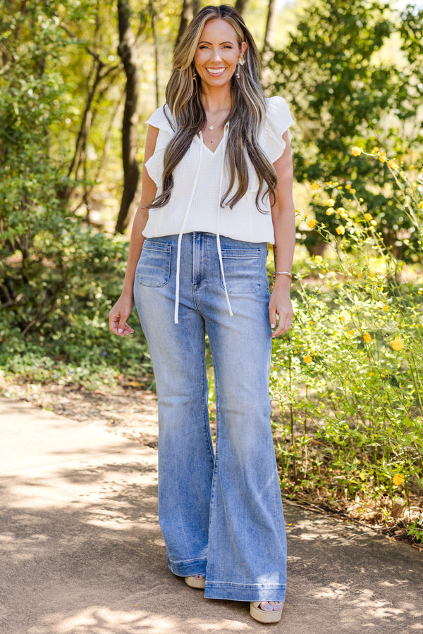 Chic Soul plus size clothing, mid-waisted medium wash straight boot-cut jeans with a subtle silver button detailing 
