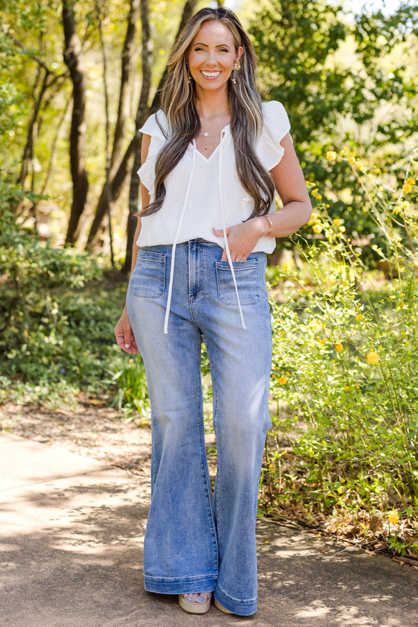 Chic Soul plus size clothing, mid-waisted medium wash straight boot-cut jeans with a subtle silver button detailing 