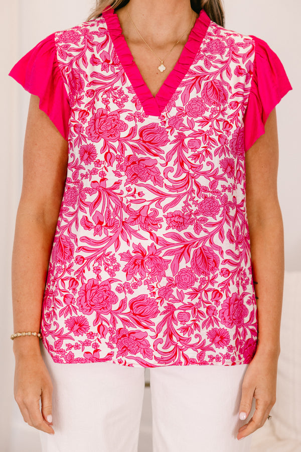 Plus Size pink floral print top with flutter sleeves and a ruffled V-neckline.