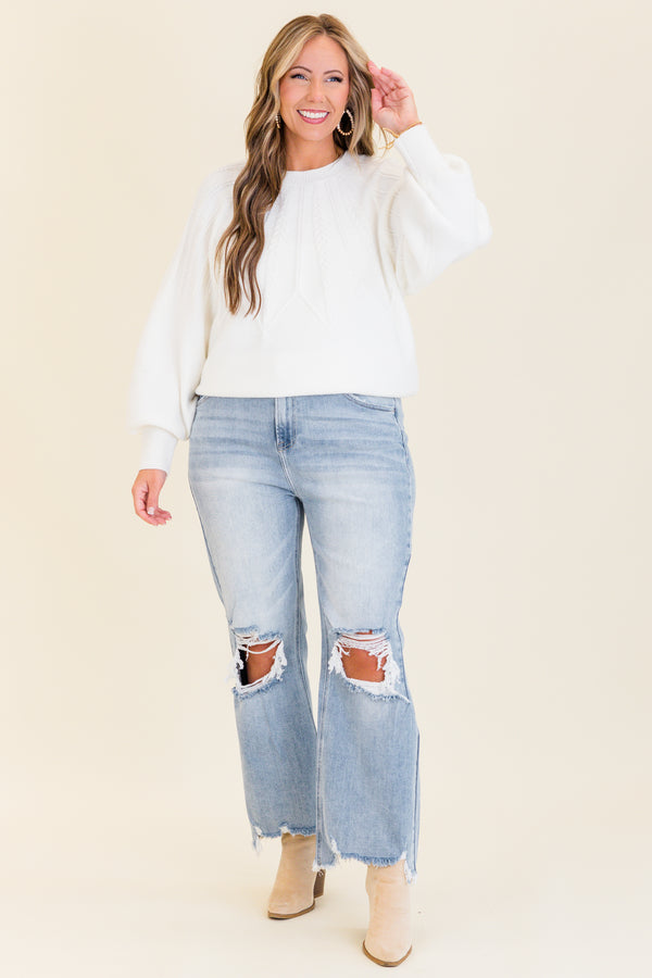 Chic Soul plus size clothing, light wash denim jeans with slight flare at the bottom with holes and distressing on knees with raw distressed hem at the bottom