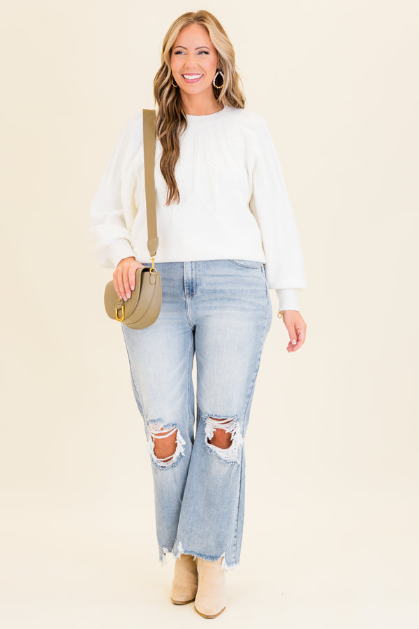 Chic Soul plus size clothing, light wash denim jeans with slight flare at the bottom with holes and distressing on knees with raw distressed hem at the bottom