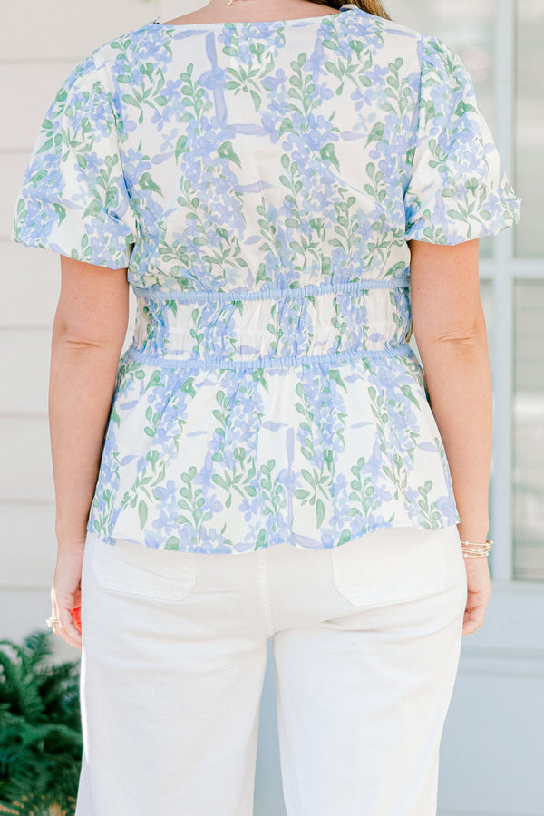 Chic soul plus size clothing, blue short sleeve babydoll top with a floral pattern and a scalloped v-neckline as well as three tie bows going down the  chest 
