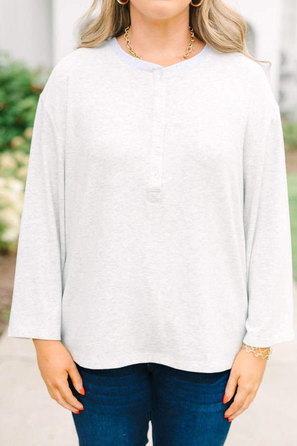 Heather grey oversized knit henley top with a button placket and dropped shoulders.