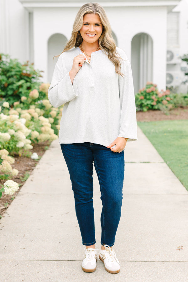 Heather grey oversized knit henley top with a button placket and dropped shoulders.