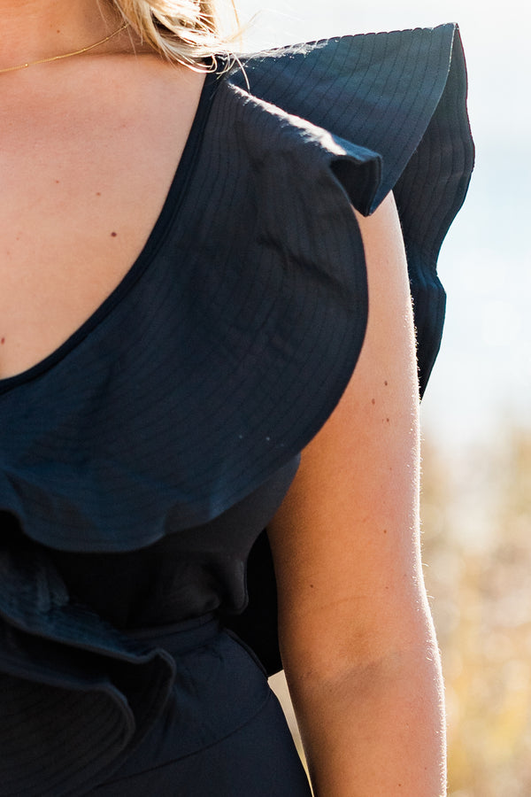 Chic Soul plus size clothing, overlaying ruffled black swimsuit with a deep-v-neckline and a tie closure belt