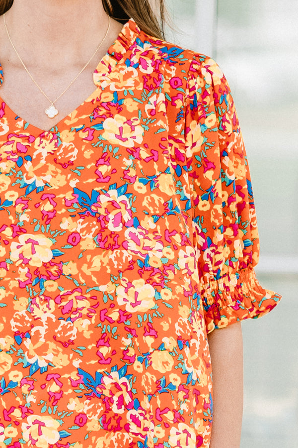 Chic soul plus size clothing, Orange top with three quarter length sleeves, multi-color floral pattern, and a partial ruffle collar 