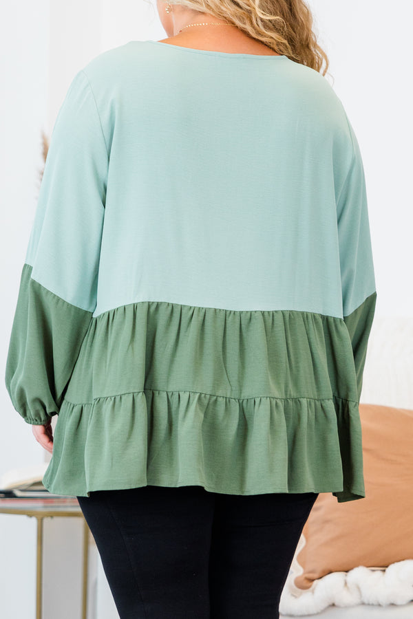 Plus Size colorblock sage green long sleeve top with a tiered babydoll hem and round neckline.