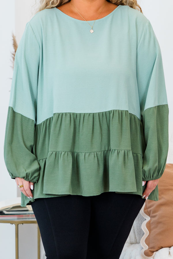 Plus Size colorblock sage green long sleeve top with a tiered babydoll hem and round neckline.