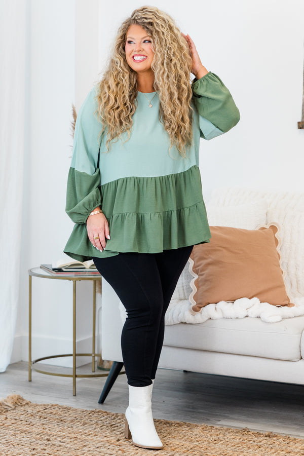 Plus Size colorblock sage green long sleeve top with a tiered babydoll hem and round neckline.