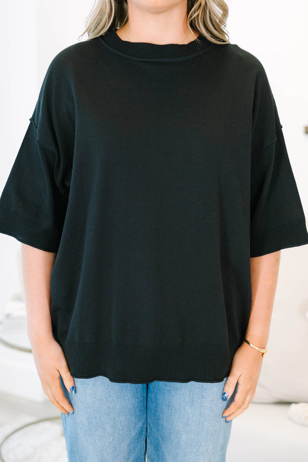 Plus size black short sleeve sweater with a flowy fit and ribbed hem