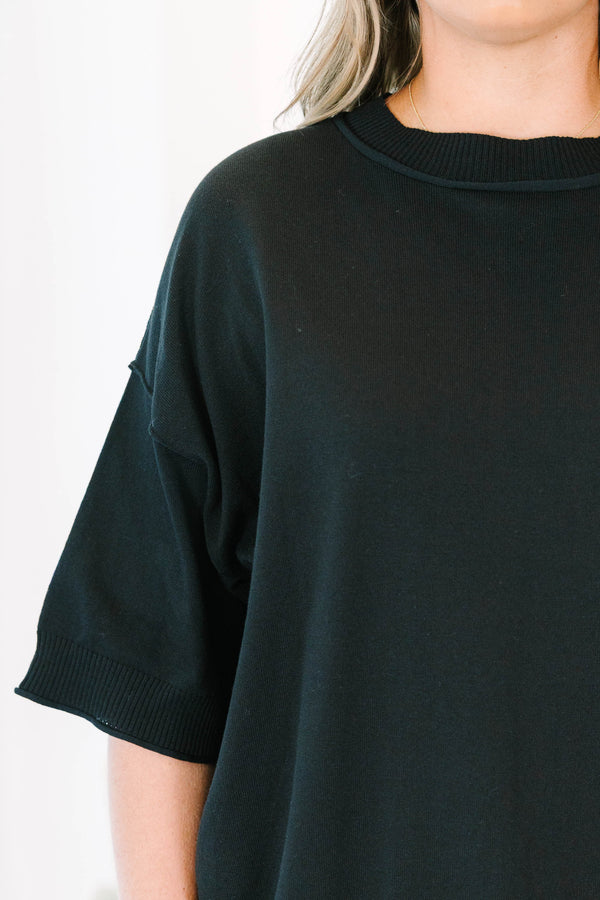 Plus size black short sleeve sweater with a flowy fit and ribbed hem