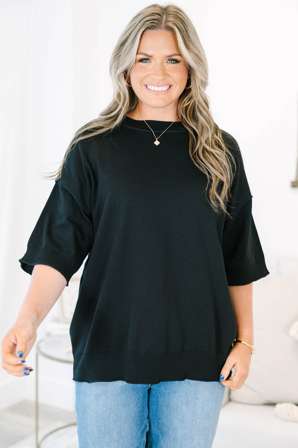 Plus size black short sleeve sweater with a flowy fit and ribbed hem