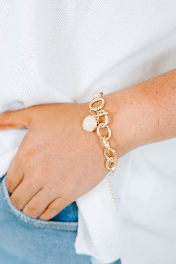 Plus Size gold chain link bracelet with a round white stone charm and toggle closure.