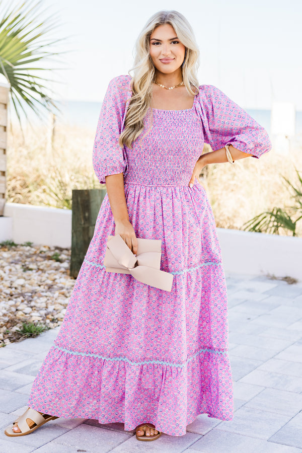 Plus Size pink ditsy floral maxi dress with a smocked bodice, puff sleeves, and tiered ric rac skirt.
